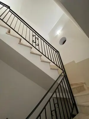 a white staircase with black railings in a house at Quattrociocchi apartment in Bagheria