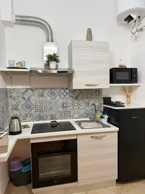 a kitchen with a sink and a stove top oven at Quattrociocchi apartment in Bagheria