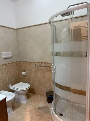 a bathroom with a toilet and a shower at Quattrociocchi apartment in Bagheria