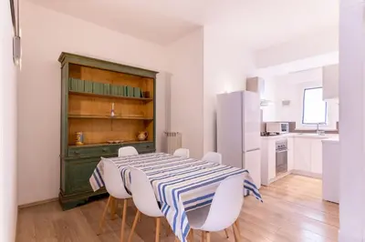 a kitchen and dining room with a table and chairs at Eye on the Politeama - L'occhio sul Politeama in Palermo