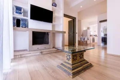 a living room with a fireplace and a glass table at Eye on the Politeama - L'occhio sul Politeama in Palermo