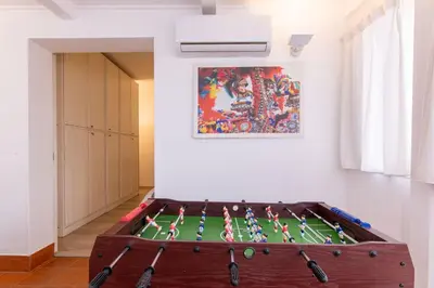 a room with a table with a soccer field at Eye on the Politeama - L'occhio sul Politeama in Palermo