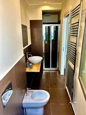 a bathroom with a toilet and a sink and a shower at TorreNormanna Prestige House near Cefalù in Mandra Capreria