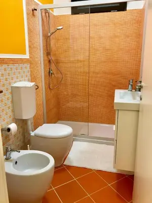 a bathroom with a shower and a toilet and a sink at TorreNormanna Prestige House near Cefalù in Mandra Capreria