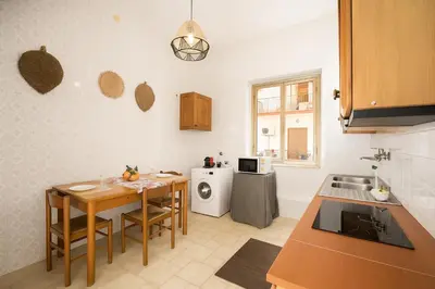 a kitchen with a table and a sink and a stove at - Palermo - Sferracavallo sul mare in Palermo