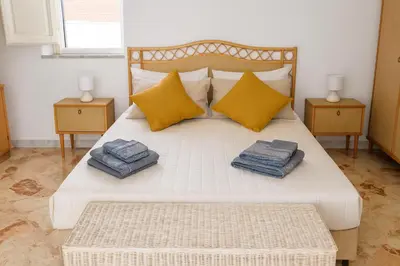 a bedroom with a bed with two pillows on it at - Palermo - Sferracavallo sul mare in Palermo