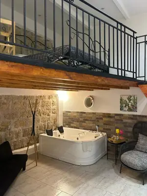 a bath tub in a living room with a staircase at La casetta nel vicolo in Palermo