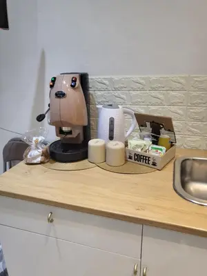 a counter top with a coffee maker and cups on it at La casetta nel vicolo in Palermo