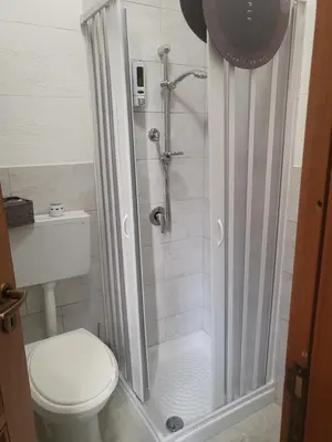a bathroom with a shower and a toilet at La casetta nel vicolo in Palermo