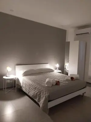 a bedroom with a bed with two towels on it at Amunì o 123 in Palermo