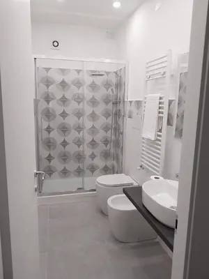 a bathroom with a shower and a toilet and a sink at Amunì o 123 in Palermo