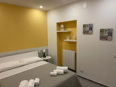 a bedroom with a bed with towels on it at Amunì o 123 in Palermo