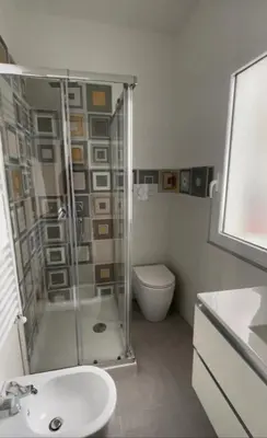 a bathroom with a shower and a toilet and a sink at Amunì o 123 in Palermo
