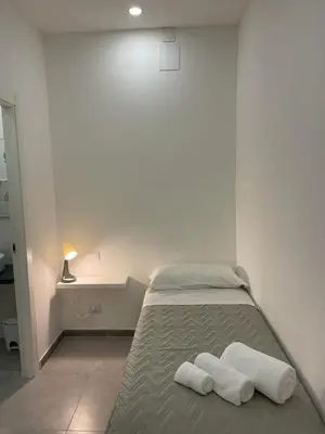 a bedroom with a bed with two towels on it at Amunì o 123 in Palermo