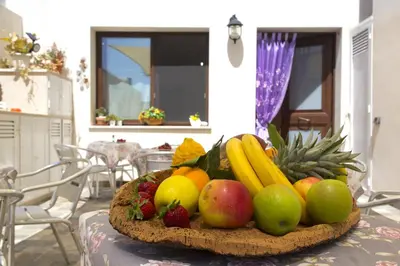 a bowl of fruit sitting on a table at B&B Piano di Sopra in San Vito lo Capo