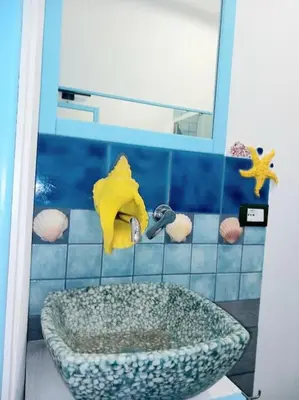 a bathroom with a sink and a mirror at Villa Mondello Terraces & Jacuzzi in Mondello