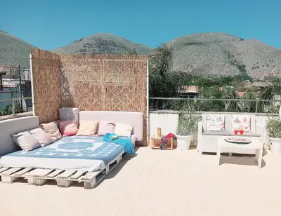 a bed sitting on top of a patio at Villa Mondello Terraces & Jacuzzi in Mondello