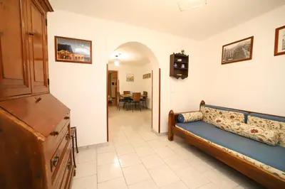 a bedroom with a couch and a living room at Colonna House Casa vacanze tra la Zisa e la Cattedrale in Palermo