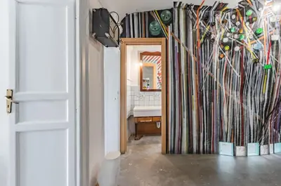 a hallway with a mirror and a sink in a room at Ballarò Market Street Art Stylish Flat x10 in Palermo