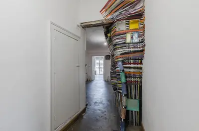 a hallway with a bunch of books on a wall at Ballarò Market Street Art Stylish Flat x10 in Palermo