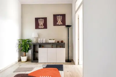 a living room with an orange rug and a white cabinet at [The historical center of Palermo] La Dolce Vita in Palermo