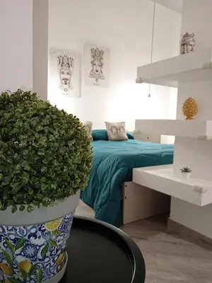a bedroom with a bed and a potted plant at Sea sicily home in Santa Flavia