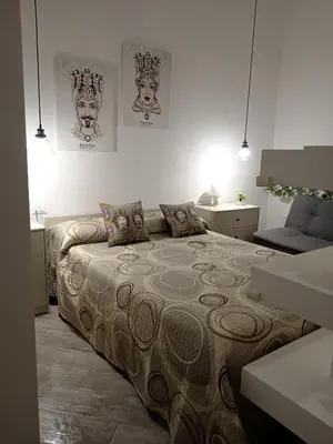 a bedroom with a large bed in a room at Sea sicily home in Santa Flavia