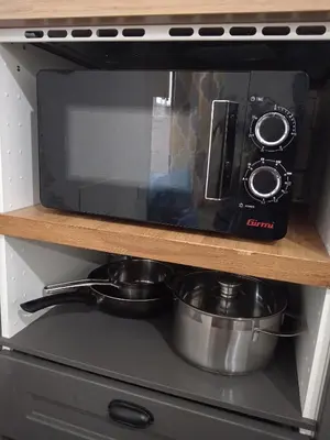 a microwave oven with two pots and pans in it at Sea sicily home in Santa Flavia