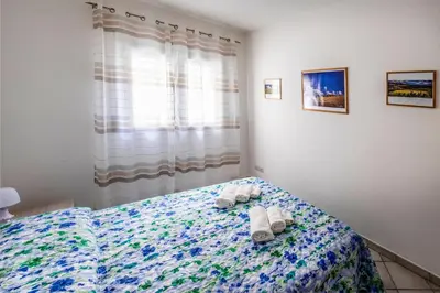 a bedroom with a bed with towels on it at Battigia Casa Vacanze-Alcamo Marina in Alcamo Marina
