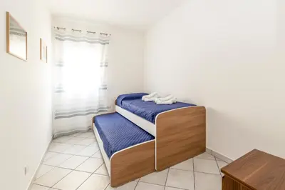 a bedroom with two beds and a window at Battigia Casa Vacanze-Alcamo Marina in Alcamo Marina