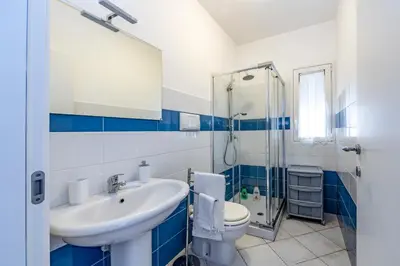 a bathroom with a sink and a toilet and a shower at Battigia Casa Vacanze-Alcamo Marina in Alcamo Marina