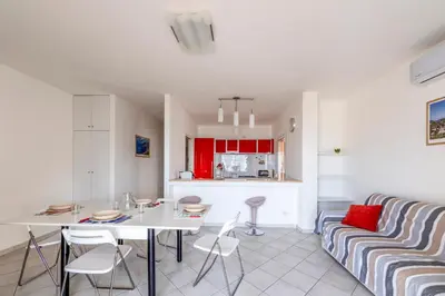 a kitchen and living room with a table and a couch at Battigia Casa Vacanze-Alcamo Marina in Alcamo Marina