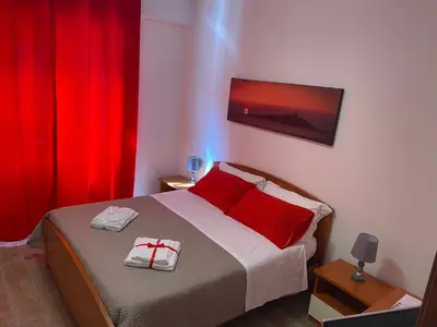 a bedroom with a bed with two red pillows at Casa Narciso - Mondello in Mondello