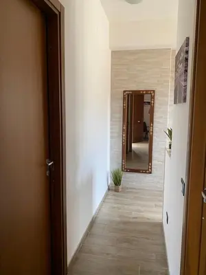 a hallway with a door and a mirror at Casa Narciso - Mondello in Mondello