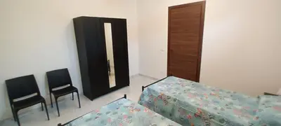 a room with two chairs and a table and a door at Palazzo DS in Castellammare del Golfo