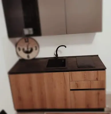 a kitchen counter with a sink and a clock at Piazza Vittoria Apartment in Carini