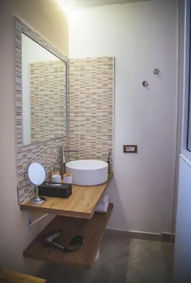 a bathroom with a tub and a sink and a mirror at ZA HOUSE in Palermo