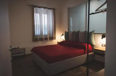 a bedroom with a red bed and a window at ZA HOUSE in Palermo
