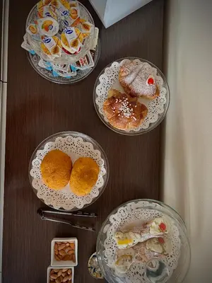 a table with four plates of food on it at Sikelìa Bed & Breakfast in Carini