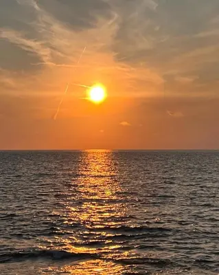 a sunset over the ocean with the sun in the sky at Sikelìa Bed & Breakfast in Carini