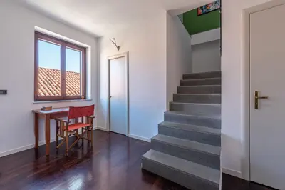 a hallway with stairs and a table and a window at Schiavuzzo Apartment with Terrace by Wonderful Italy in Palermo