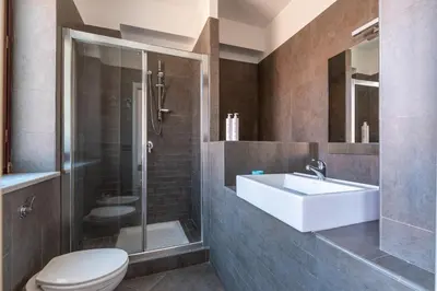 a bathroom with a toilet and a sink and a shower at Schiavuzzo Apartment with Terrace by Wonderful Italy in Palermo