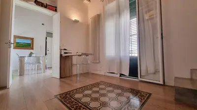 a living room with a table and a rug on the floor at SHANTI HOLIDAY HOUSE in Palermo