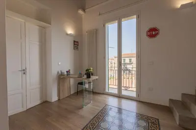 a room with a door and a table and a window at SHANTI HOLIDAY HOUSE in Palermo