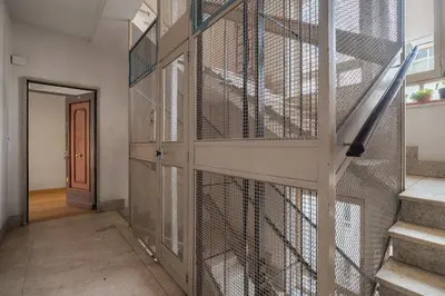 a hallway with a dog cage in a house at Giusà by DomuSicily in Palermo