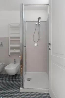 a bathroom with a shower with a toilet and a sink at Giusà by DomuSicily in Palermo