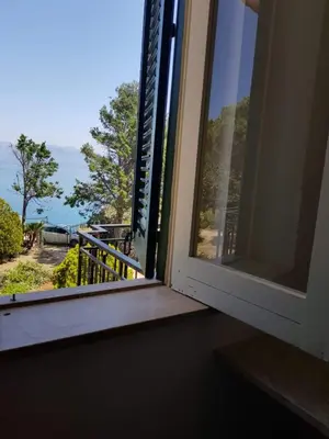 a window with a view of the ocean at Appartamenti Cala Rossa (Antonella) in Castellammare del Golfo