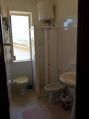 a bathroom with a toilet and a sink at Appartamenti Cala Rossa (Antonella) in Castellammare del Golfo