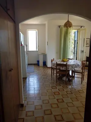 a kitchen and dining room with a table and chairs at Appartamenti Cala Rossa (Antonella) in Castellammare del Golfo