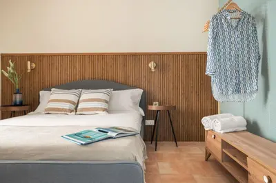 a bedroom with a bed with a book on it at Sole di Giada by DomuSicily in Mondello